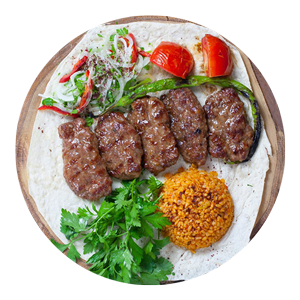 Turkish Kofte Kebab with Pepper, Rice, Salad and Tomato on a Bread Served at Gooz BBQ House Burntisland